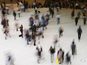 People walk inside the Oculus, the new transit station at the World Trade Center in New York on June 15, 2017.