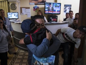 Lourdes de Leon hugs her 6-year-old son Leo Jeancarlo de Leon as they are reunited at the shelter "Nuestras Raíces" in Guatemala City, Tuesday, Aug. 7, 2018.