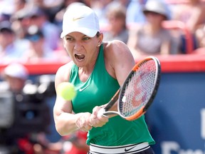Simona Halep of Romania returns to Sloane Stephens of the United States during the final of the Rogers Cup tennis tournament Sunday, Aug. 12, 2018 in Montreal.