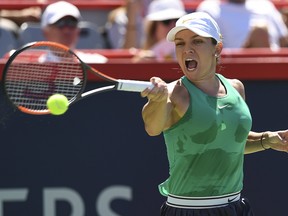 Simona Halep of Romania hits a return against Ashleigh Barty of Australia during day six of the Rogers Cup at IGA Stadium on Aug. 11, 2018 in Montreal.