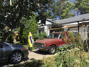 In this Tuesday, July 31, 2018 photo workers clean up a home where a homeowner shot and killed an intruder and was then killed by police responding to calls of a disturbance in Aurora, Colo. (AP Photo/Colleen Slevin)
