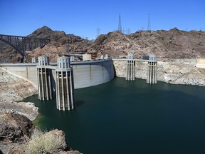 In this May 31, 2018, file photo, the low level of the water line is shown on the banks of the Colorado River at the Hoover Dam in Hoover Dam, Ariz. (AP Photo/Ross D. Franklin, File)