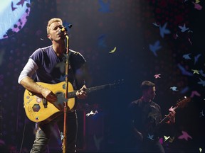 Singer Chris Martin (left) and bassist Guy Berryman of Coldplay perform at Rogers Place in Edmonton, Alberta on Tuesday, September 26, 2017.