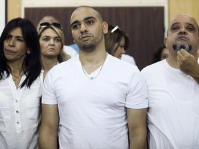 Elor Azaria, flanked by his parents, sits inside a Israeli military court in Tel Aviv , Sunday, July 30, 2017. (AP Photo/Dan Balilty, Pool)
