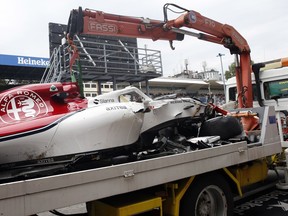 The car of Sauber driver Marcus Ericsson is carried away by a truck after he crashed during a free practice at the Monza racetrack, in Monza, Italy, Friday, Aug. 31, 2018.