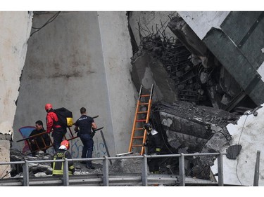 Rescues work among the rubble of the collapsed Morandi highway bridge in Genoa, northern Italy, Tuesday, Aug. 14, 2018.
