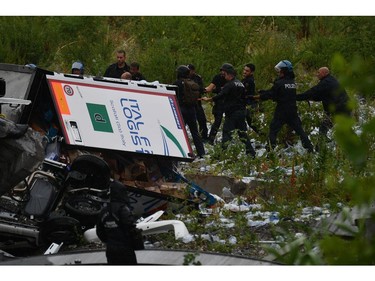 Rescues work among the debris of the collapsed Morandi highway bridge in Genoa, Tuesday, Aug. 14, 2018.