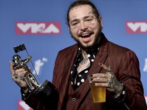IN this Monday, Aug. 20, 2018 photo, Post Malone poses with the award for song of the year for "Rockstar" in the press room at the MTV Video Music Awards at Radio City Music Hall in New York. Post Malone is thanking fans for their prayers now that his private jet that blew two tires taking off from a small New Jersey airport has landed safely in New York, Tuesday, Aug. 21.