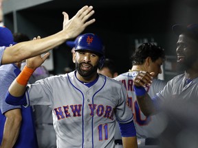 New York Mets' Jose Bautista (11) high-fives teammates in the dugout Tuesday, Aug. 14, 2018, in Baltimore. (AP Photo/Patrick Semansky)