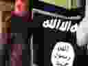 In this July 8, 2017 file image taken from FBI video and provided by the U.S. Attorney's Office in Hawaii on July 13, 2017, Army Sgt. 1st Class Ikaika Kang holds an Islamic State group flag after allegedly pledging allegiance to the terror group at a house in Honolulu. 