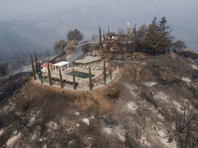 A swimming pool is all that remains of a hilltop home after being burned by a wildfire that swept through Shasta County an area west of Redding, Calif., Friday, Aug. 10, 2018.