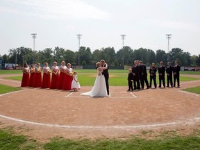 Kristopher Weisheit and Brittany Birk took their vows Saturday, Aug. 25, 2018, from home plate at League Stadium in Huntingburg, Ind., while their groomsmen and bridesmaids lined up, respectively, along the first and third baselines.
