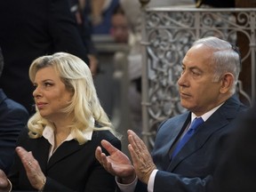 Israeli Prime Minister Benjamin Netanyahu, right, and his wife Sara Netanyahu applaud during their visit to the synagogue in Vilnius, Lithuania, Sunday, Aug. 26, 2018.