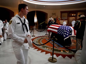 U.S. Naval cadets walk past the casket during a memorial service for Senator John McCain at the Arizona Capitol on August 29, 2018, in Phoenix. (Jae C. Hong /AFP/Getty Images)