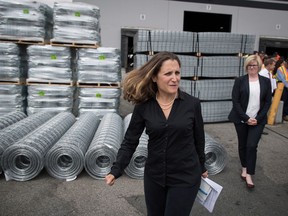 Minister of Foreign Affairs Chrystia Freeland, front, leaves a news conference after touring Tree Island Steel, in Richmond, B.C., on Friday, August 24, 2018.