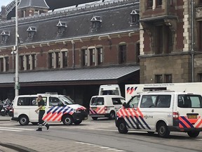 Dutch police officers near the scene of a stabbing attack near the central daily station in Amsterdam, the Netherlands, Friday Aug. 31, 2018. Police the Dutch capital shot and wounded a suspect Friday following a stabbing at the central railway station. Amsterdam police said in a series of tweets that two people were injured in the stabbing and the suspect was then shot by officers.