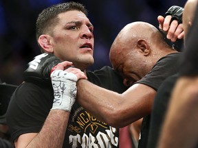 Nick Diaz and Anderson Silva come together in an embrace following their fight at the MGM Grand Garden Arena in Las Vegas on Saturday, Jan. 31, 2015.