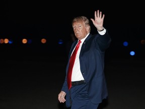 U.S. President Donald Trump waves as he arrives on Air Force One at Morristown Municipal Airport, in Morristown, N.J., Saturday, Aug. 4, 2018, en route to Trump National Golf Club in Bedminster, N.J., after attending a rally in Lewis Center, Ohio.