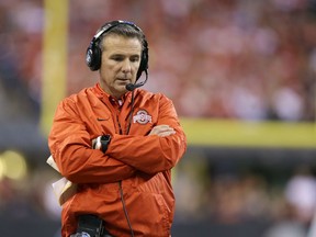 In this Dec. 2, 2017, file photo, Ohio State coach Urban Meyer stands along the sideline during the first half of the team's Big Ten championship NCAA game against Wisconsin in Indianapolis.