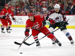 In this Feb. 10, 2018, file photo, Carolina Hurricanes' Jeff Skinner (53) stretches for the puck with Colorado Avalanche's Matt Nieto (83) defending in Raleigh, N.C.