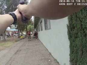 This still image taken from a body camera video released by the Los Angeles Police Department shows a Los Angeles Police Officer confronting an armed suspect in the Van Nuys neighborhood of Los Angeles on June 16, 2018.  Los Angeles police released a video showing officers fatally shooting an armed suspect and a woman he was holding hostage.  The video released Tuesday, July 31,  marked the second time LAPD gunfire has killed a bystander in the last six weeks.  Officers were called to the Central Lutheran Church after a man allegedly stabbed his ex-girlfriend.   (Los Angeles Police Department via AP)