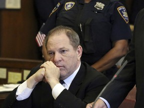 In this July 9, 2018 file photo, Harvey Weinstein attends his arraignment in court, in New York.  Weinstein's lawyers want a New York court to throw out sexual assault charges against him.