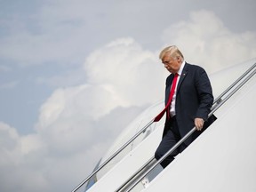 President Donald Trump walks down the stairs as he arrives on Air Force One at Morristown Municipal Airport in Morristown, N.J., Friday, Aug. 17, 2018, en route to Trump National Golf Club in Bedminster, N.J.