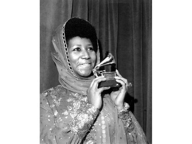 In this March 3, 1975 file photo, singer Aretha Franklin poses with her Grammy Award for for best female R&B vocal performance for "Ain't Nothing Like the Real Thing" at the 17th Annual Grammy Award presentation in New York.