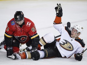 Anaheim Ducks right wing Ondrej Kase (25) celebrates his goal as Calgary Flames defenceman Brett Kulak (61) looks away in Calgary, Wednesday, March 21, 2018. (THE CANADIAN PRESS/Jeff McIntosh)