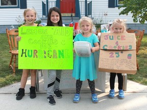 A group of elementary school-aged Good Samaritans were selling lemonade and cookies on the corner of Devine and Savoy streets to raise money for victims of Hurricane Irma. From left to right are: Chaeli, 7, Honour, 8, Nevaeh, 4 and Audrey, 6. (Carl Hnatyshyn/SunMedia)