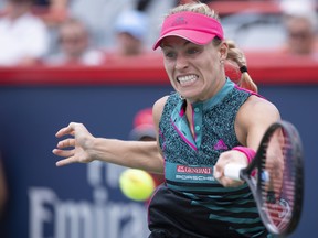 Angelique Kerber of Germany returns to Elize Cornet of France during second round of play at the Rogers Cup tennis tournament Wednesday August 8, 2018 in Montreal. THE CANADIAN PRESS/Paul Chiasson