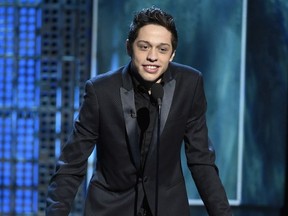 FILE - In this March 14, 2015, file photo, Pete Davidson speaks at a Comedy Central Roast at Sony Pictures Studios in Culver City, Calif. Davidson says he's the "luckiest guy in the world" after wasting little time pursuing Ariana Grande. In the September 2018 GQ magazine, Davidson says he told Grande on the day he met her, "Hey, I'll marry you tomorrow."
