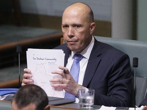 Australian former Home Affairs Minister Peter Dutton sits in the back left seat in Parliament in Canberra, Australia, Wednesday, Aug. 22, 2018. (AP Photo/Rod McGuirk)