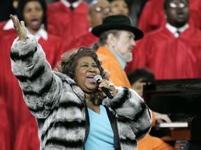 In this Feb. 5, 2006 file photo, Aretha Franklin and Dr. John, background on piano, perform the national anthem before the Super Bowl XL football game in Detroit.