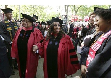 In this May 29, 2014 file photo, singer Aretha Franklin, center, walks in a procession during Harvard University commencement ceremonies in Cambridge, Mass., where Franklin was presented with an honorary Doctor of Arts degree.