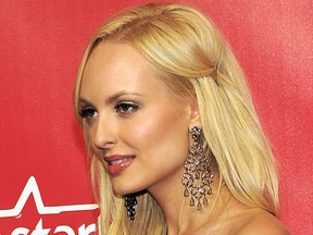 Playboy "bunny" Shera Bechard arrives at the MusiCares Person of the Year gala in Los Angeles on Feb. 10, 2012. (AP Photo/Chris Pizzello)