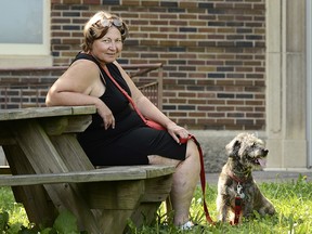 Rene Halligan poses for a portrait with her dog, Ruby, 4, in Trumansburg, N.Y., Thursday, Aug. 16, 2018. (AP Photo/Heather Ainsworth)