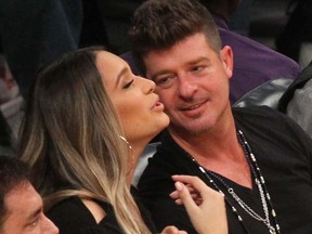 Robin Thicke and April Love Geary take in a Lakers game in Los Angeles on March 16, 2018.