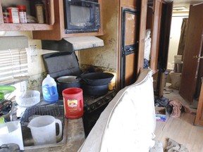 Various items litter the kitchen of a makeshift living compound in Amalia, N.M., on Friday, Aug. 10, 2018, where five adults were arrested on child abuse charges and remains of a boy were found.