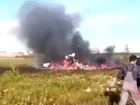 In this image made video, smoke rises from a crash side of a Russian helicopter Mi-8 crashed shortly after takeoff in Vankor, above the Arctic Circle in Siberia, Russia, Saturday, Aug. 4, 2018.