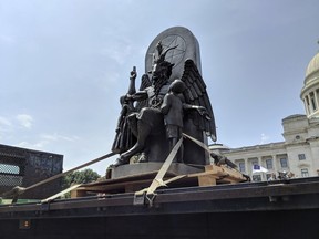 The Satanic Temple unveils its statue of Baphomet, a winged-goat creature, at a rally for the first amendment in Little Rock, Ark., Thursday, Aug. 16, 2018.