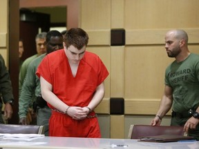 In this Friday, Aug. 3, 2018 file photo, school shooting suspect Nikolas Cruz arrives at a Broward County courtroom for a hearing in Fort Lauderdale, Fla.