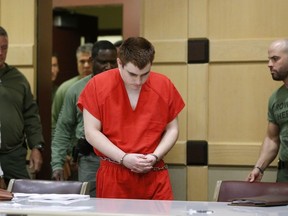 In this Friday, Aug. 3, 2018 file photo, school shooting suspect Nikolas Cruz arrives at a Broward County courtroom for a hearing in Fort Lauderdale, Fla.