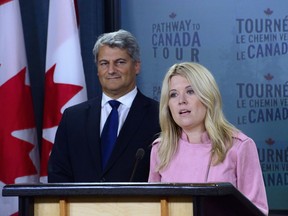 Michelle Rempel, Shadow Minister for Immigration, Refugees and Citizenship, and Gerard Deltell, Shadow Minister for the Treasury Board, hold a press conference at the National Press Theatre in Ottawa on Wednesday, Aug. 22, 2018.