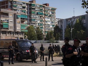 Catalan police officers cordon off the area near a police station, following an attack in Cornella de Llobregat near Barcelona, Spain, Monday, Aug. 20, 2018. Police in Barcelona say they have shot a man who attacked officers with a knife at a police station in the Spanish city, saying in a tweet Monday the attacked occurred just before 6 a.m. in the Cornella district of the city.