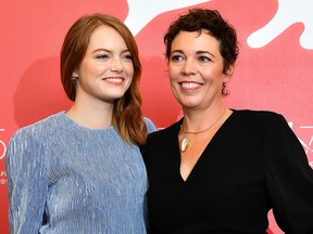 Emma Stone (L) and Olivia Colman attend a photocall for the film "The Favourite" presented in competition on Aug. 30, 2018 during the 75th Venice Film Festival at Venice Lido.