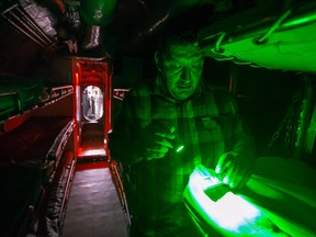 In this Saturday, Aug. 18, 2018 photo, Ramon Meza, founder and lead paranormal investigator of G.H.O.S.T. Houston, places a voice recorder on a bunk in the main berthing area aboard the USS Cavalla during an all-night investigation inside the submarine at Seawolf Park in Galveston, Texas.
