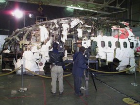 Journalists record the partially reconstructed cockpit of Swissair Flight 111 at a news conference in Halifax on Monday, Dec. 4, 2000. The fate of many millions of dollars of valuables said to be carried aboard Swissair Flight 111 when it went down off Nova Scotia 20 years ago this Sunday remains unknown.