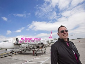 Steven Greenway, President and CEO of Swoop Airlines, poses for a photo in front of one of their Boeing 737 planes on display during a media event, Tuesday, June 19, 2018 at John C. Munro International Airport in Hamilton, Ontario.
