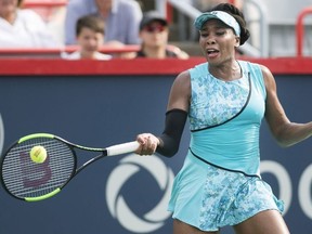 Venus Williams of the United States returns to Caroline Dolehide of the United States during their first round match at the Rogers Cup tennis tournament in Montreal, Monday, August 6, 2018.